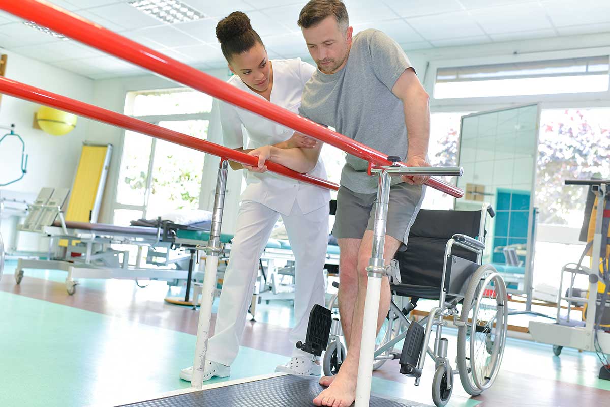 man-in-rehab-trying-to-walk-on-a-treadmill